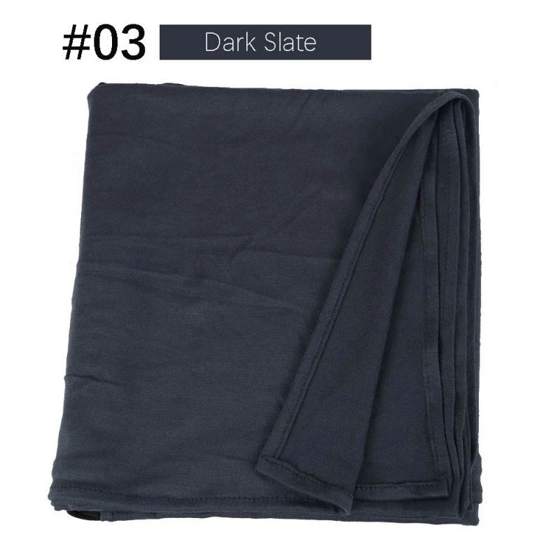 Dark slate rectangular hijab folded on a white background.