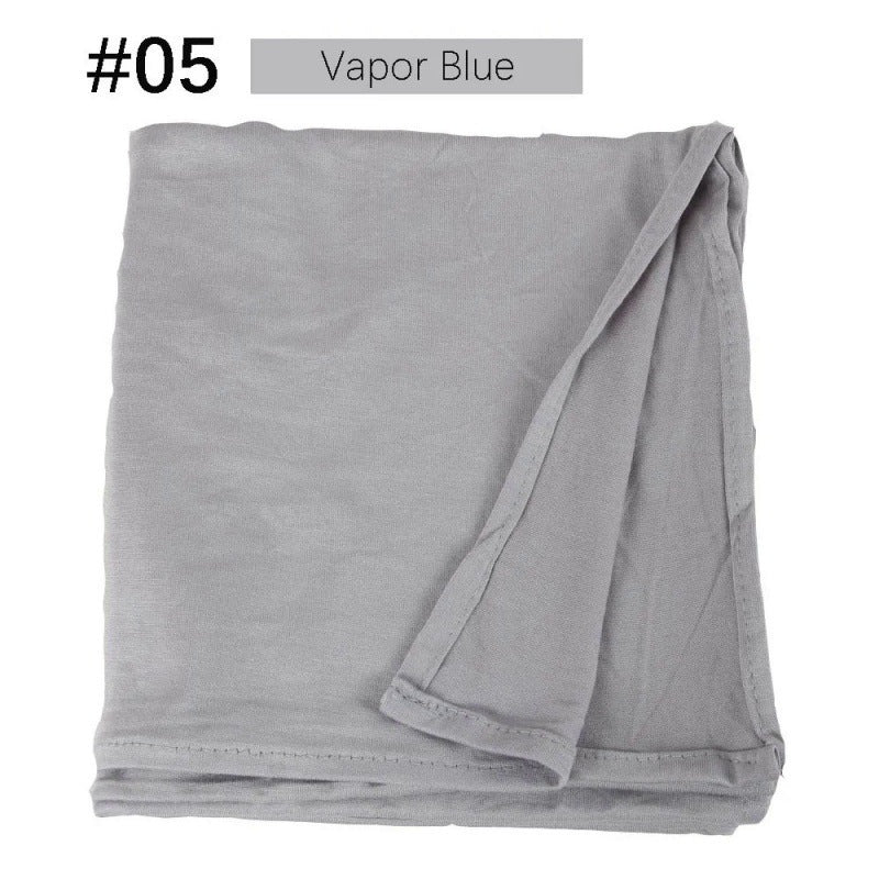 Light grey-blue rectangular hijab folded on a white background.